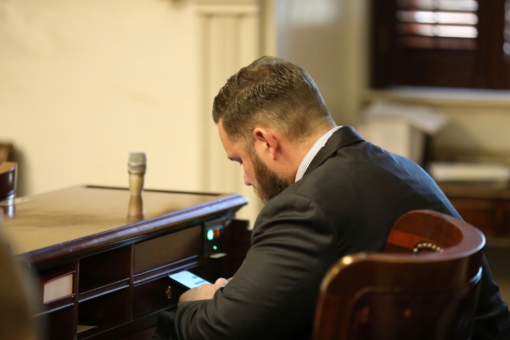 FILE - Republican South Carolina Rep. R.J. May of Lexington sits at his new desk during the organizational session for the House on Tuesday, Dec. 3, 2024, in Columbia, S.C. (AP Photo/Jeffrey Collins,File)