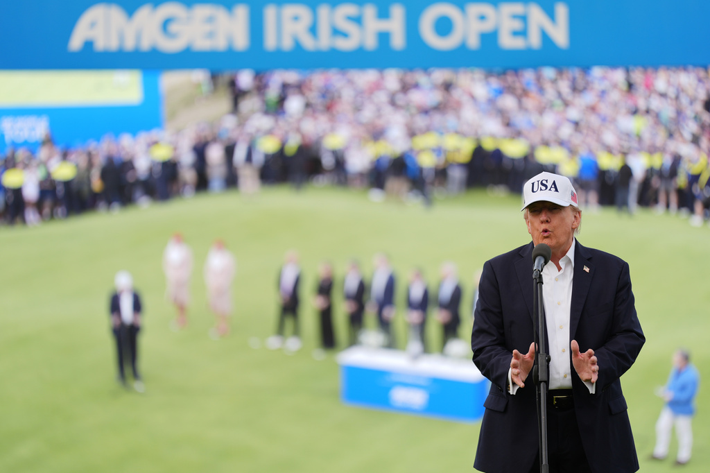 U.S. President Donald Trump speaks prior to presenting the winners trophy to Shane Lowry of Ireland during the Irish Open golf tournament at Trump International Golf Links in Doonbeg, Ireland, Sunday, Sept. 13, 2026. (AP Photo/Julia Demaree Nikhinson)