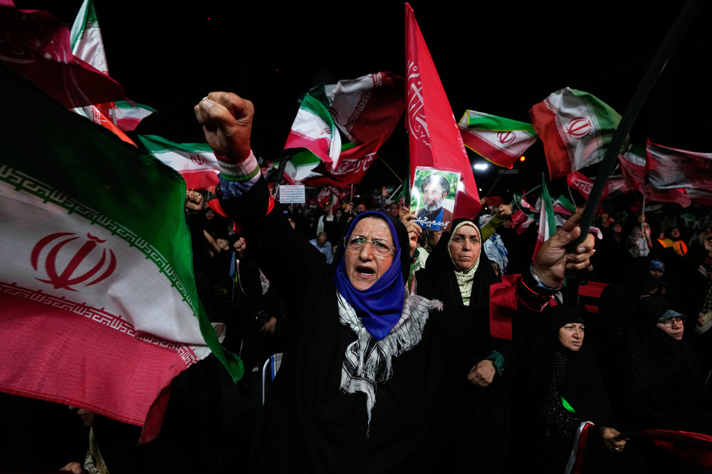 A pro-government demonstrator chants slogan during a gathering in a square in Tehran, Wednesday, Aug. 26, 2026. (AP Photo/Vahid Salemi)