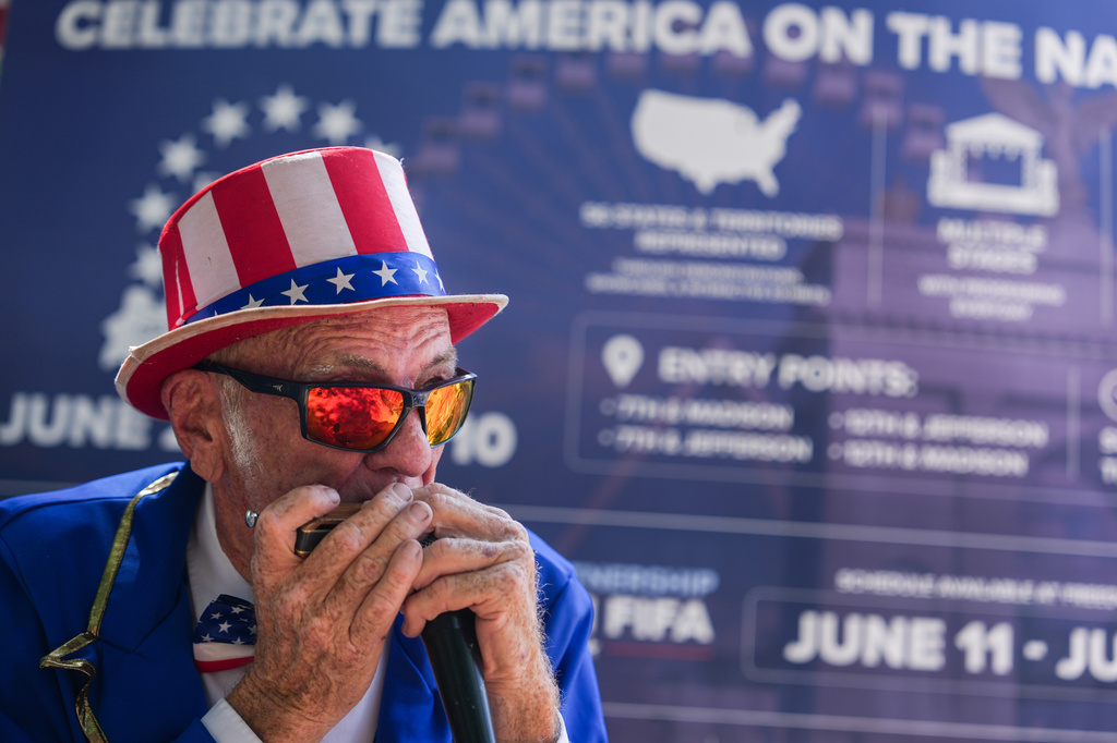 Duane Schwingel plays a harmonica on the National Mall, Friday, July 3, 2026, in Washington. (AP Photo/Julia Demaree Nikhinson)