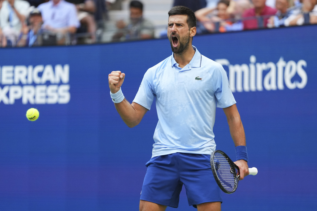 Novak Djokovic, of Serbia, reacts after scoring a point against Carlos Alcaraz, of Spain, during the men's singles semifinals of the U.S. Open tennis championships, Friday, Sept. 5, 2025, in New York. (AP Photo/Kirsty Wigglesworth)