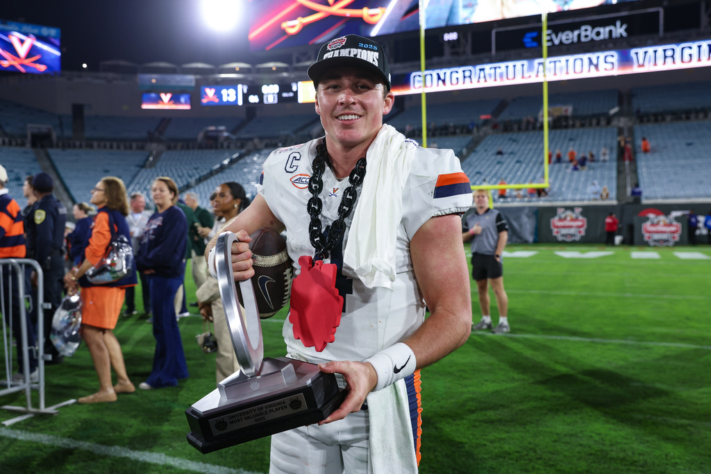 Virginia quarterback Chandler Morris poses with his MVP trophy after his team defeated Missouri in the Gator Bowl NCAA college football game in Jacksonville, Fla., Saturday, Dec. 27, 2025. (AP Photo/Gary McCullough)