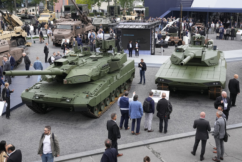 FILE - Visitors gather by a Leopard 2 A8 tank, left, and a Leopard 2A-RC-3.0 tank at the Eurosatory Defense and Security exhibition, Wednesday, June 19, 2024 in Villepinte, north of Paris, On Wednesday Sept. 3, 2025. (AP Photo/Michel Euler/File)