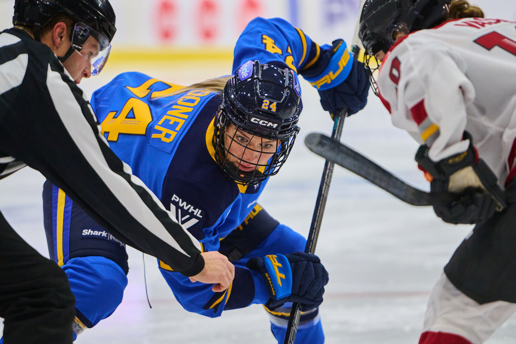 Toronto Sceptres' Natalie Spooner (24) faces off against Ottawa Charge's Alexa Vasko (10) during second period PWHL hockey action in Toronto, Tuesday, Dec. 23, 2025. (Sammy Kogan/The Canadian Press via AP)