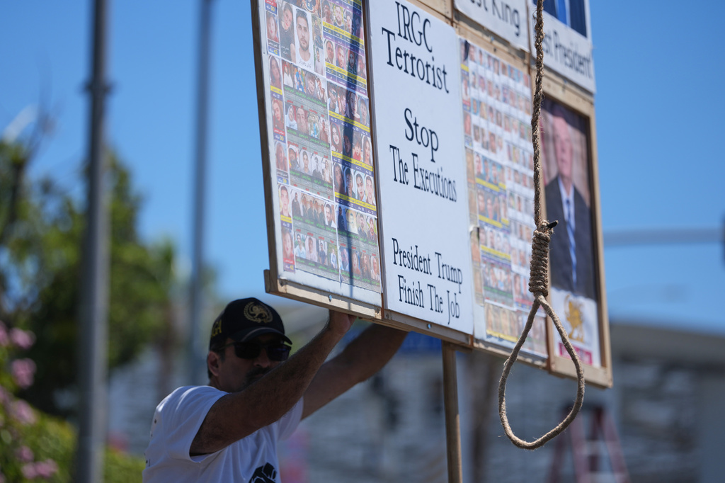 A protester holds a sign with a noose outside Los Angeles Stadium before the World Cup Group G soccer match between Iran and New Zealand in Inglewood, Calif., near Los Angeles, Monday, June 15, 2026. (AP Photo/Jae C. Hong)