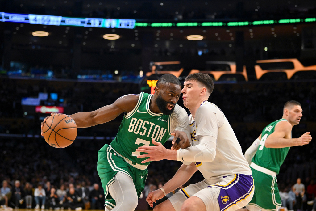 Boston Celtics guard Jaylen Brown drives to the basket against Los Angeles Lakers forward Jake LaRavia during the first half of an NBA basketball game Sunday, Feb. 22, 2026, in Los Angeles. (AP Photo/Katie Chin)