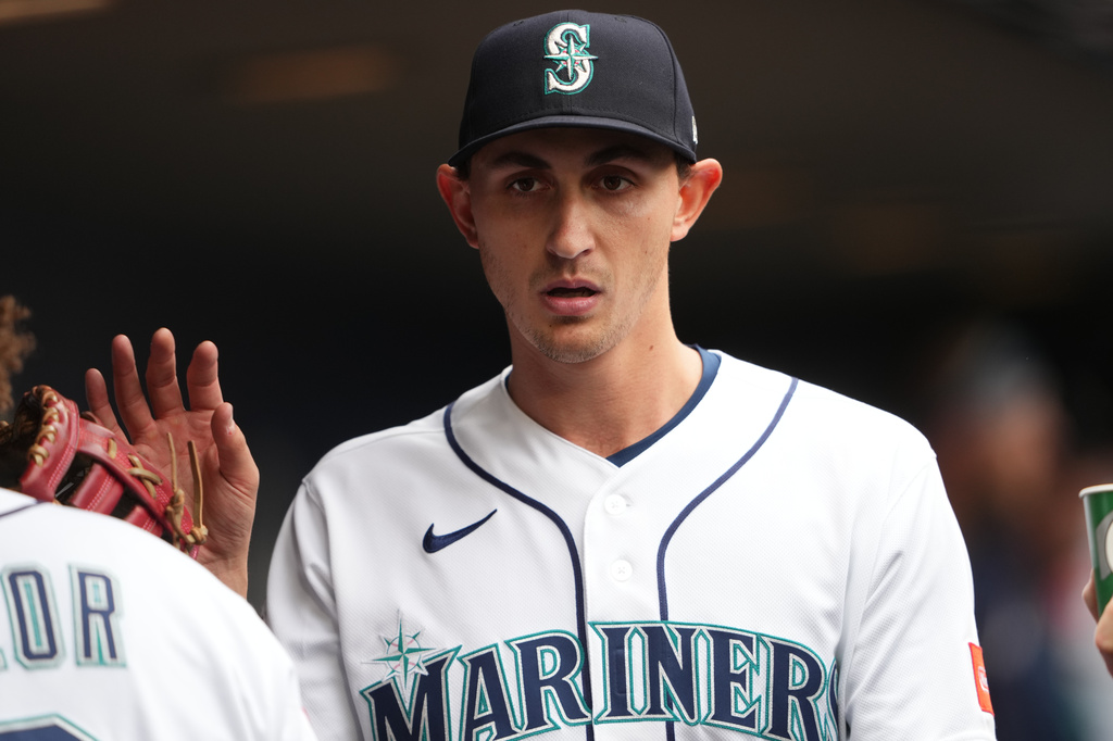Seattle Mariners starting pitcher George Kirby greets Josh Naylor in the dugout after facing the Houston Astros during the sixth inning of a baseball game, Monday, April 13, 2026, in Seattle. (AP Photo/Lindsey Wasson)