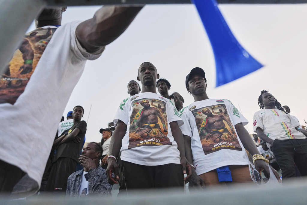 Fans of wrestler Modou Lo look on after his defeat at the national wrestling arena in Dakar, Senegal, Sunday, April 5, 2026. (AP Photo/Misper Apawu)