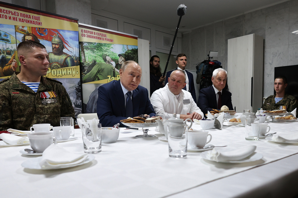 President Vladimir Putin, second left, talks servicemen, participants of a special military operation in Ukraine at the the Mandryk Central Military Clinical Hospital, in Moscow, Russia, Wednesday, Oct. 29, 2025. (Vyacheslav Prokofyev, Sputnik, Kremlin Pool Photo via AP)