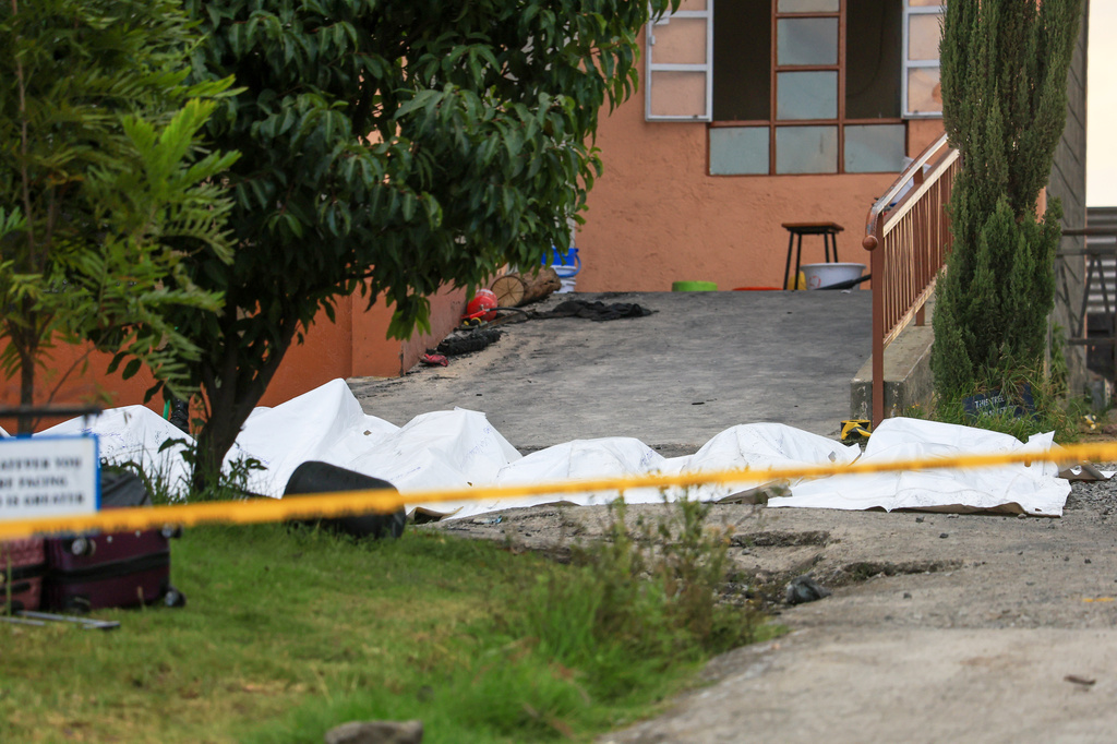 The bodies of students who died in the fire are in body bags outside the dormitory at the Utumishi Girls School in the Gilgil area, central Kenya, Thursday, May 28, 2026. (AP Photo/Andrew Kasuku)