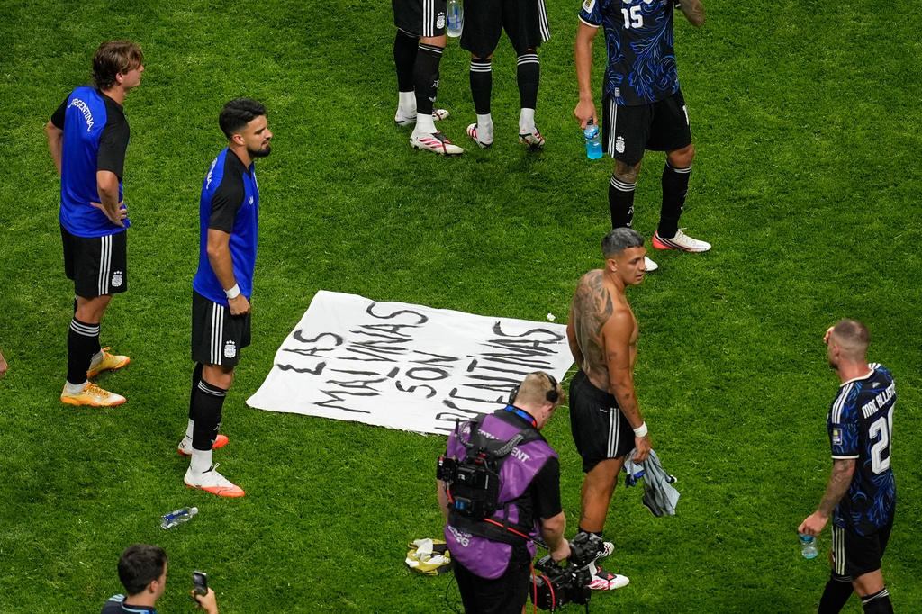 A banner with the words "The Malvinas are Argentine", referring to the Falkland Islands, lays on the pitch at the end of the World Cup semifinal soccer match between England and Argentina in Atlanta, Wednesday, July 15, 2026. (AP Photo/Mike Stewart)