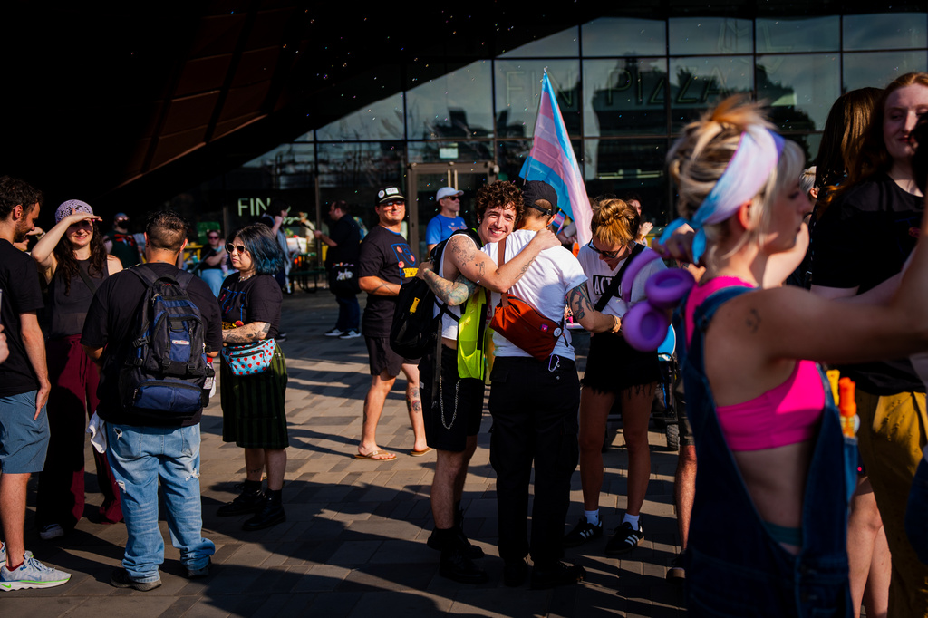 Demonstrators rally in support of transgender athletes in women's sports outside of Barclay's Center before the WNBA basketball game between the Indiana Fever and the New York Liberty, Saturday, Aug. 22, 2026, in New York. (AP Photo/Angelina Katsanis)