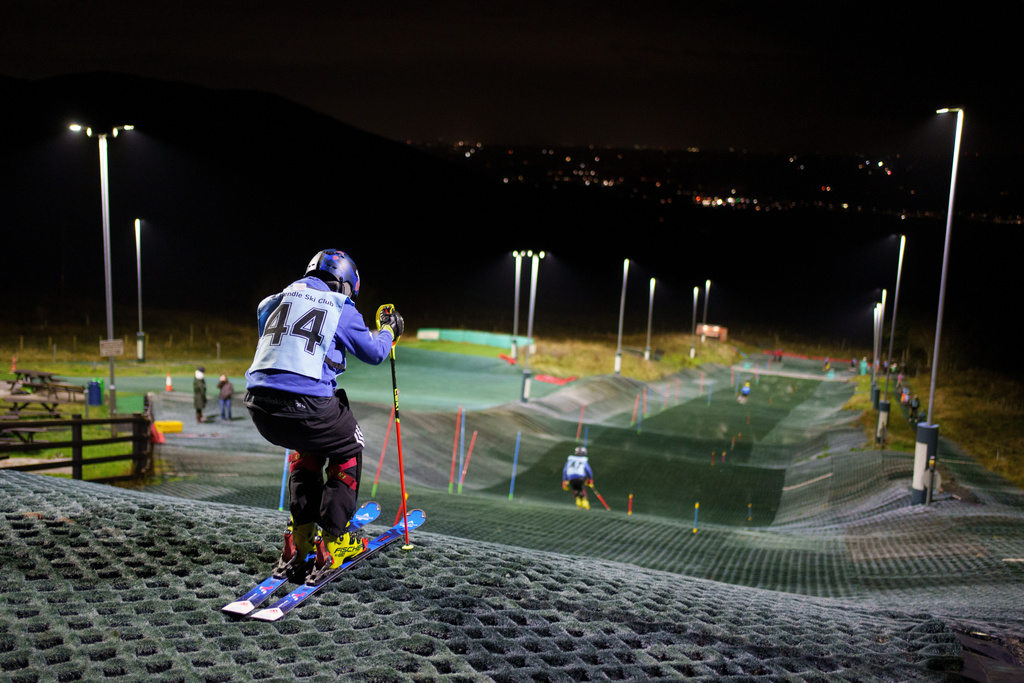 Competitors warm up before an inter-club ski meeting at Pendle Ski Club in Clitheroe, England, Tuesday, Oct. 28, 2025. (AP Photo/Jon Super)