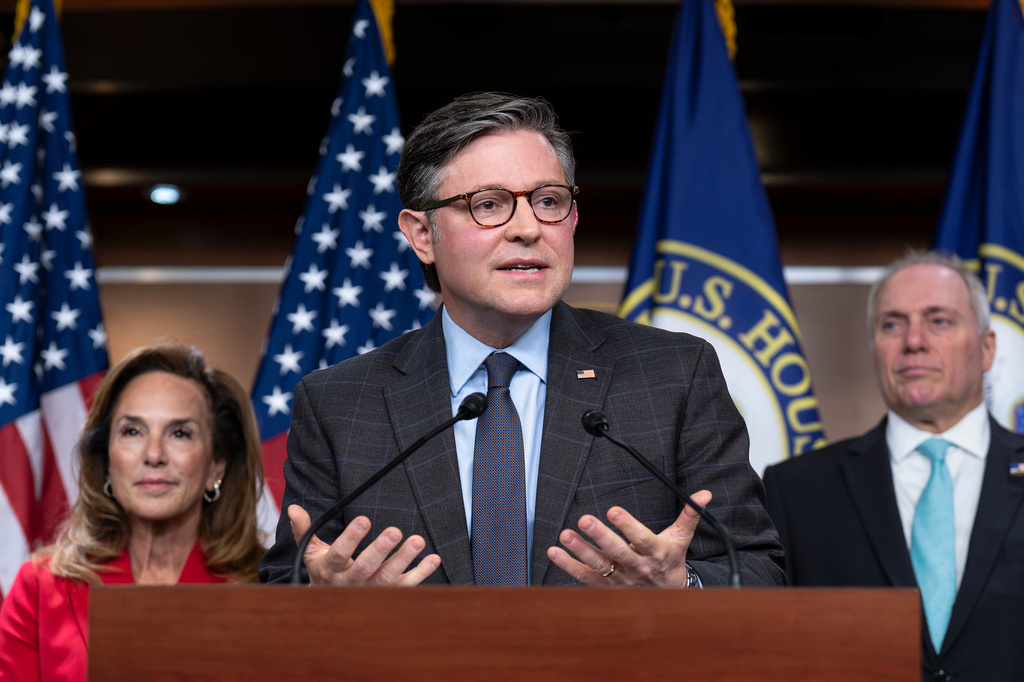 With election season getting underway, Speaker of the House Mike Johnson, R-La., center, flanked by Rep. Lisa McClain, R-Mich., left, and House Majority Leader Steve Scalise, R-La., praises the policies of President Donald Trump as he meets with reporters ahead of a vote on a stopgap funding bill and a resolution targeting socialist policies, during a news conference at the Capitol in Washington, Tuesday, Sept. 1, 2026. (AP Photo/J. Scott Applewhite)