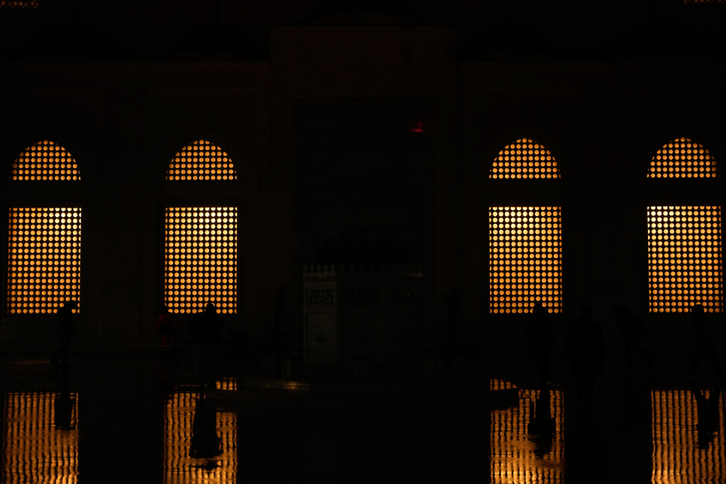 Muslim worshippers arrive to attend Eid al-Fitr prayers outside a mosque in Istanbul, Friday, March 20, 2026. (AP Photo/Khalil Hamra)