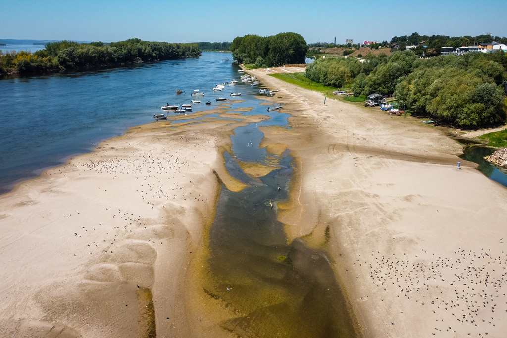 FILE - A usually submerged patch of land rises from the surface of the Danube River due to low levels of the water following an extended period of drought in Corabia, Romania, July 29, 2026. (AP Photo/ Nicolae Dumitrache, File)