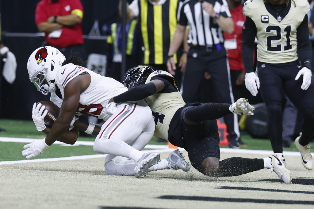 Arizona Cardinals wide receiver Marvin Harrison Jr., left, makes a touchdown catch against New Orleans Saints cornerback Kool-Aid McKinstry during the first half of an NFL football game Sunday, Sept. 7, 2025, in New Orleans. (AP Photo/Butch Dill)