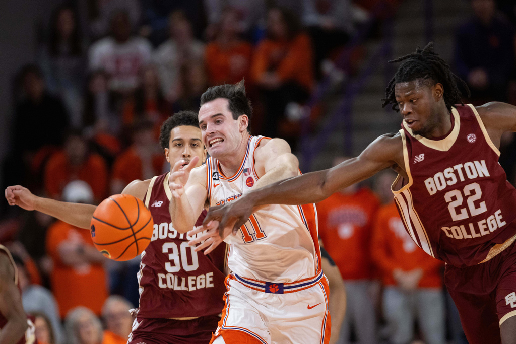 Clemson forward Nick Davidson (11) and Boston College forward Jayden Hastings (22) chase a loose ball during the first half of an NCAA college basketball game Tuesday, Jan. 13, 2026, in Clemson, S.C. (AP Photo/Scott Kinser)
