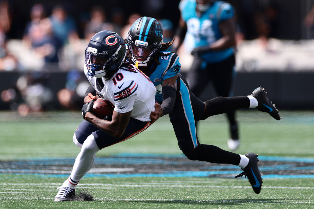 Carolina Panthers cornerback Will Lee III (24) tackles Chicago Bears wide receiver Luther Burden III (10) during the first half of an NFL football game, Sunday, Sept. 13, 2026, in Charlotte, N.C. (AP Photo/Scott Kinser)
