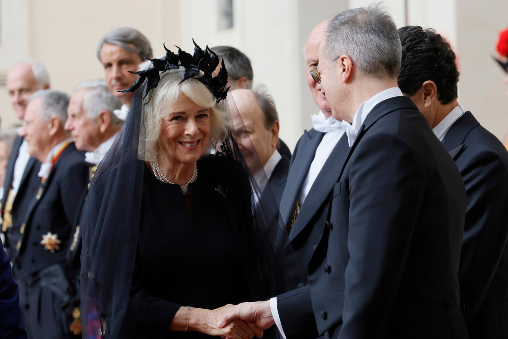 Britain's Queen Camilla arrives with King Charles III in the St. Damasus Courtyard at the Vatican for a state visit, where they will meet with Pope Leo XIV and pray with him in the Sistine Chapel, Thursday, Oct. 23, 2025. (Cecilia Fabiano/LaPresse via AP)