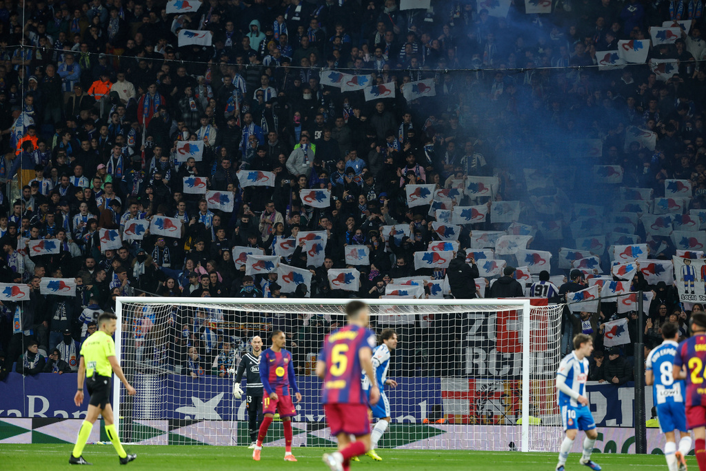 Espanyol fans hold up signs protesting Barcelona goalkeeper Joan Garcia during the Spanish La Liga soccer match between RCD Espanyol and Barcelona in Barcelona, Spain, Saturday, Jan. 3, 2026. (AP Photo/Joan Monfort)