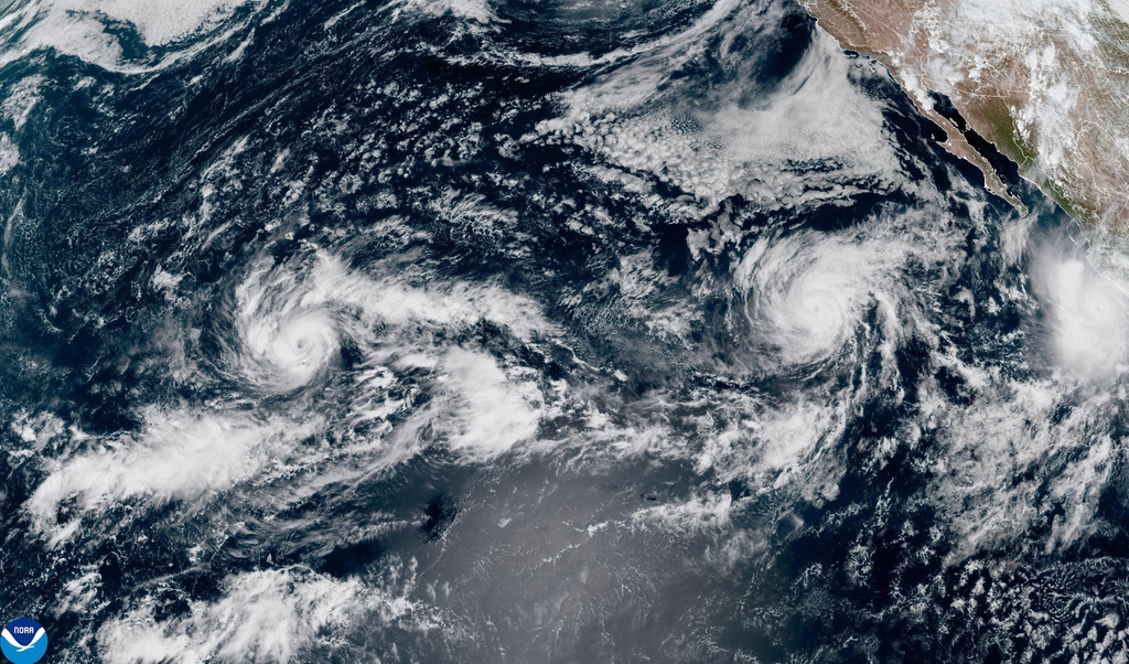 This satellite image provided by NOAA shows Tropical Storm Nolo, left, south of Hawaii; Hurricane Odalys, middle, and Hurricane Polo, right, off the coast of Mexico, in the Pacific Ocean on Thursday, Sept. 24, 2026. (NOAA via AP)