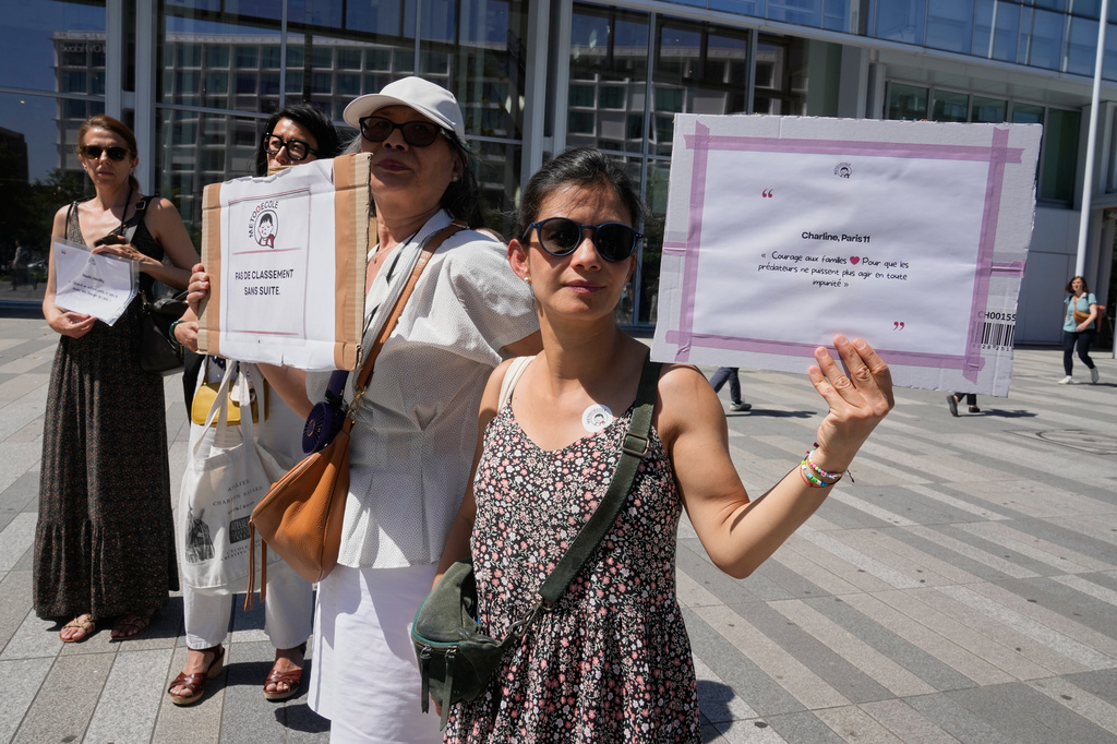 Members and supporters of the #METooEcole (#METooSchool) movement stage a protest to draw attention to a child abuse scandal in France in front of the courthouse in Paris on Tuesday May 26, 2026. (AP Photo/Michel Euler)