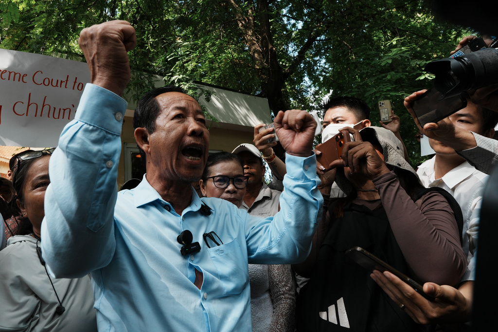 Rong Chhun, a prominent Cambodian opposition politician, gestures to his supporters after a Supreme Court hearing in Phnom Penh, Cambodia, Monday, June 15, 2026. (AP Photo/Heng Sinith)