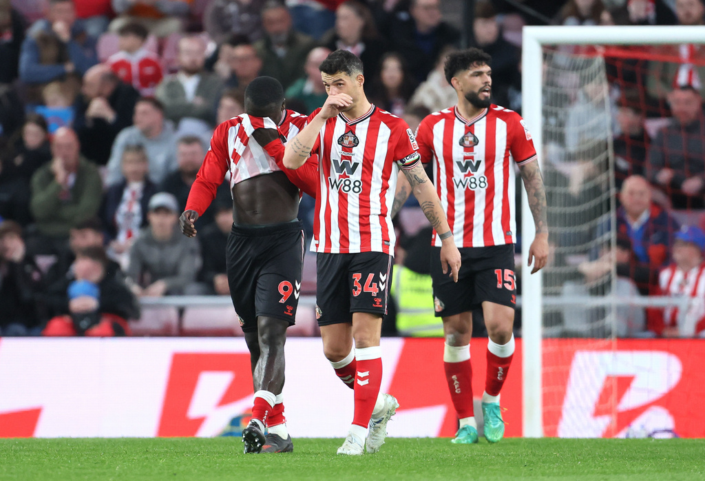 Sunderland's Granit Xhaka (34), Brian Brobbey (9) and Omar Alderete appear dejected after Nottingham Forest scored a fourth goal during the Premier League soccer match between Sunderland and Nottingham Forest, Friday, April 24, 2026, in Sunderland, England. (Richard Sellers/PA via AP)