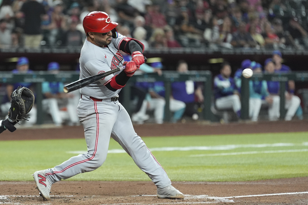 Cincinnati Reds' Jose Trevino starts his swing on a run-scoring single against the Arizona Diamondbacks during the second inning of a baseball game Friday, Aug. 22, 2025, in Phoenix. (AP Photo/Ross D. Franklin)
