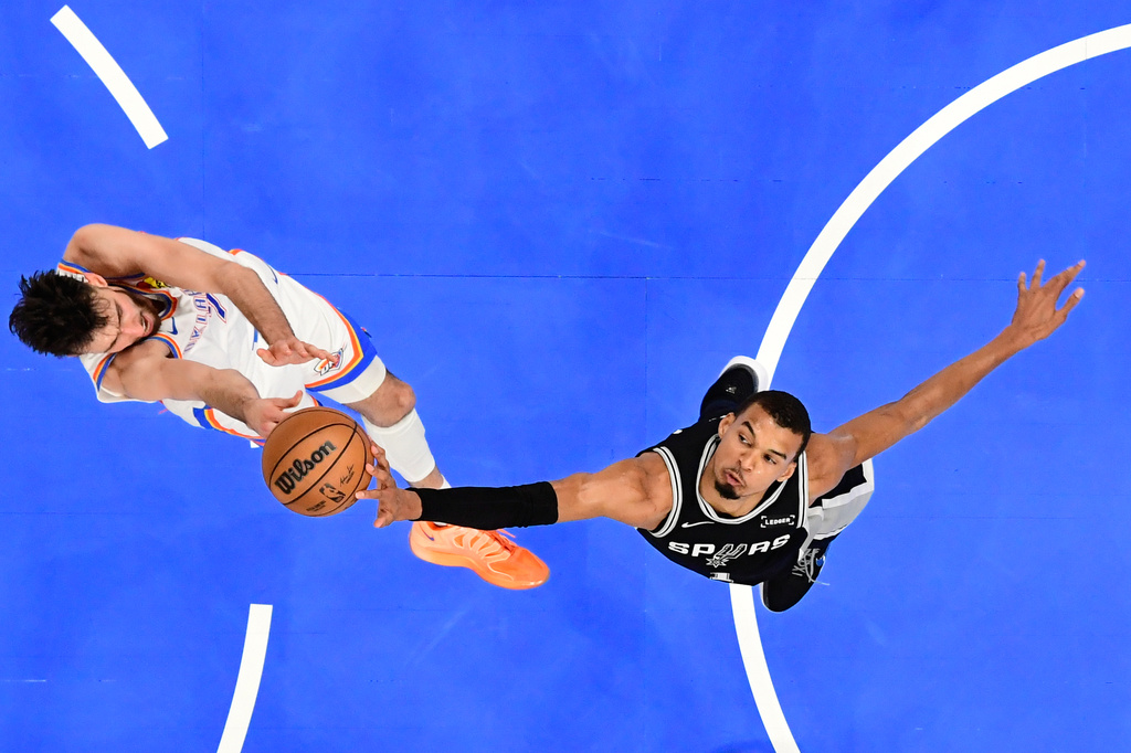 San Antonio Spurs forward Victor Wembanyama, right, blocks a shot by Oklahoma City Thunder center Chet Holmgren during the first half in Game 5 in the Western Conference finals NBA basketball playoffs series, Tuesday, May 26, 2026, in Oklahoma City. (AP Photo/Gerald Leong)