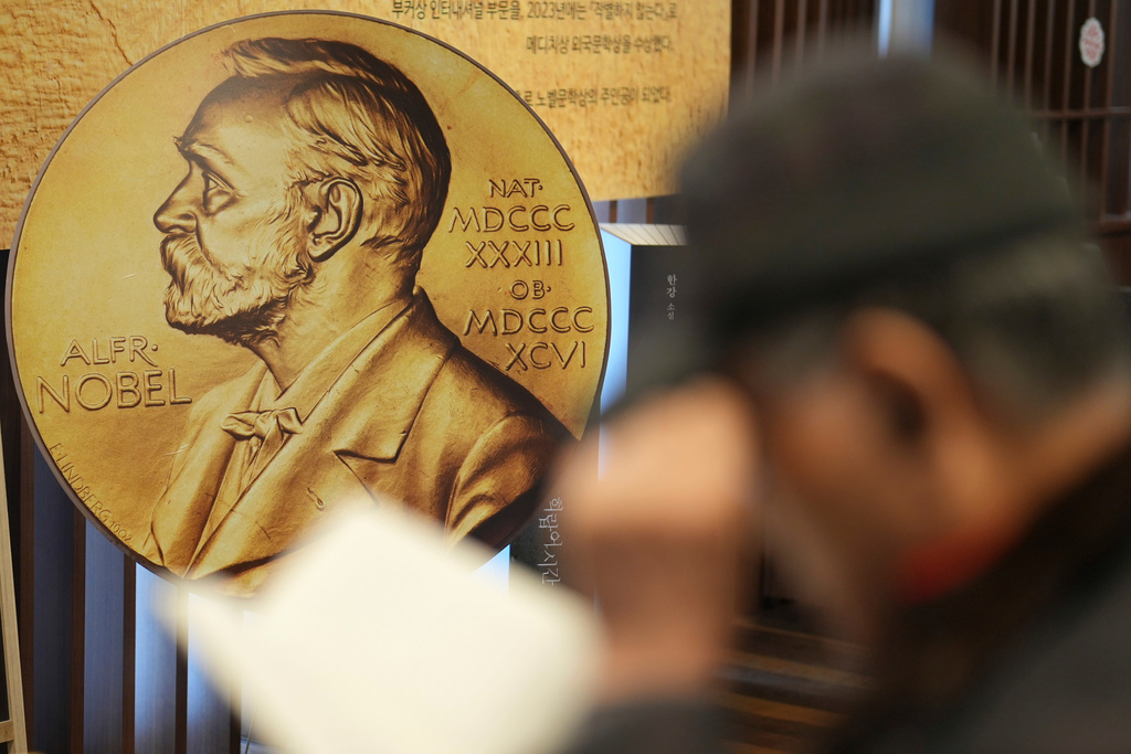 FILE - A visitor reads a book written by South Korean author Han Kang, this year's winner of the Nobel Prize in Literature, at a special section of a bookstore in Seoul, South Korea, Tuesday, Dec. 10, 2024. (AP Photo/Lee Jin-man, File)