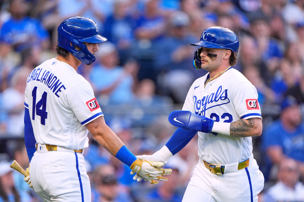 Kansas City Royals' Carter Jensen, right, celebrates with Jac Caglianone (14) after scoring on a sacrifice fly hit by Michael Massey during the second inning of a baseball game against the Baltimore Orioles, Tuesday, April 21, 2026, in Kansas City, Mo. (AP Photo/Charlie Riedel)