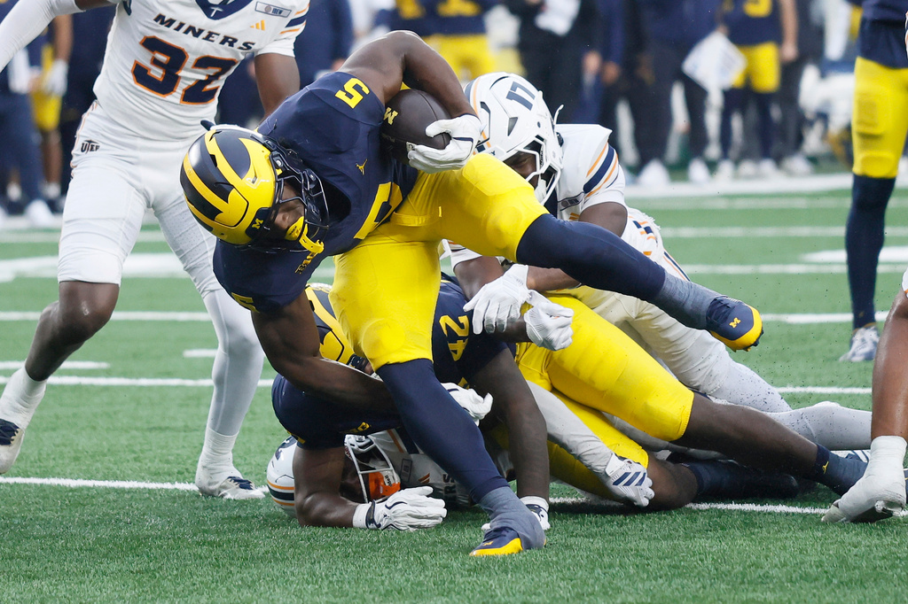 Michigan running back Savion Hiter (5) breaks away from UTEP safety Darnell Williams (17) for a touchdown during the second half of an NCAA college football game Saturday, Sept. 19, 2026, in Ann Arbor, Mich. (AP Photo/Duane Burleson)