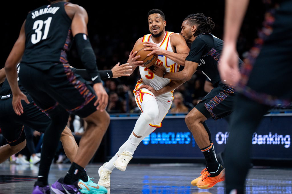 Atlanta Hawks guard CJ McCollum (3) fights through the Brooklyn Nets' defense during the first half of an NBA basketball game, Friday, April 3, 2026, in New York. (AP Photo/Angelina Katsanis)