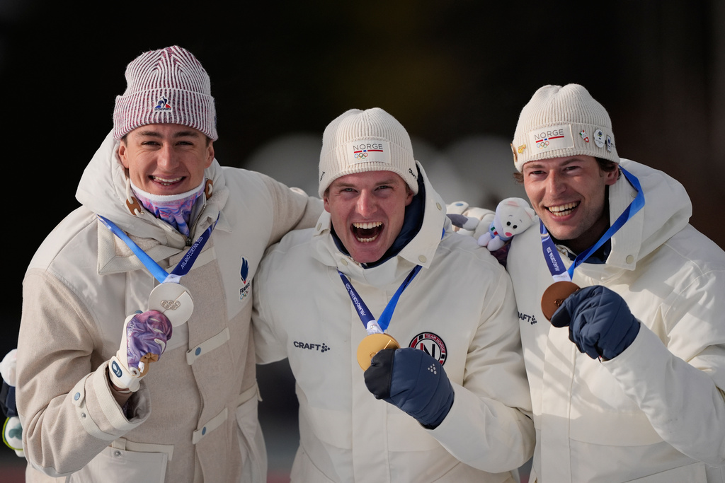 Silver medalist Eric Perrot, of France, from left, gold medalist Johan-Olav Botn, of Norway, and bronze medalist Sturla Holm Laegreid, of Norway, pose after the men's 20-kilometer individual biathlon race at the 2026 Winter Olympics in Anterselva, Italy, Tuesday, Feb. 10, 2026. (AP Photo/Mosa'ab Elshamy)