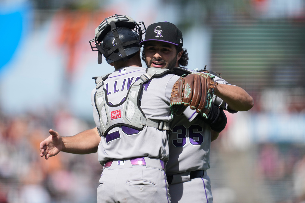 Colorado Rockies catcher Brett Sullivan, left, celebrates with pitcher Zach Agnos after a baseball game against the San Francisco Giants, Sunday, Aug. 16, 2026, in San Francisco. (AP Photo/Jeff Chiu)