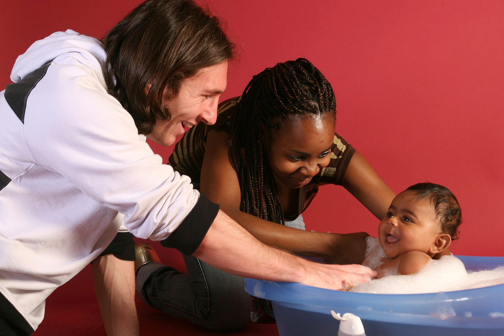 20-year-old soccer star Lionel Messi helps to bathe Lamine Yamal, who was merely six months old at the time with Yamal's mother Sheila Ebana during a photo session in Sept. 2007 in the dressing room of the Camp Nou stadium in Barcelona, Spain. (AP Photo/Joan Monfort)