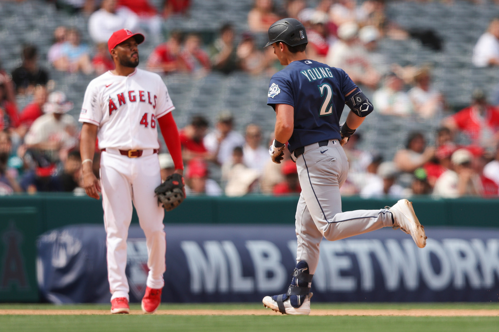 Seattle Mariners' Cole Young (2) rounds the bases after hitting a home run as Los Angeles Angels third baseman Jeimer Candelario (46) watches during the fifth inning of a baseball game, Sunday, April 5, 2026, in Anaheim, Calif. (AP Photo/Jessie Alcheh)