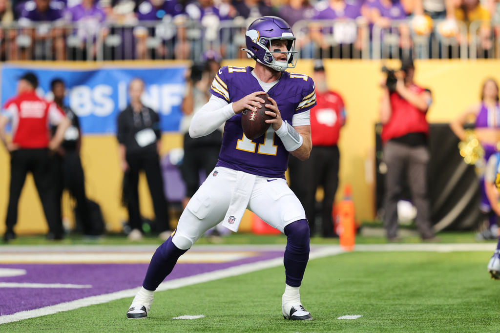 Minnesota Vikings quarterback Carson Wentz (11) drops back to pass during the first half of an NFL football game against the Green Bay Packers, Sunday, Sept. 13, 2026, in Minneapolis, Minn. (AP Photo/Bailey Hillesheim)