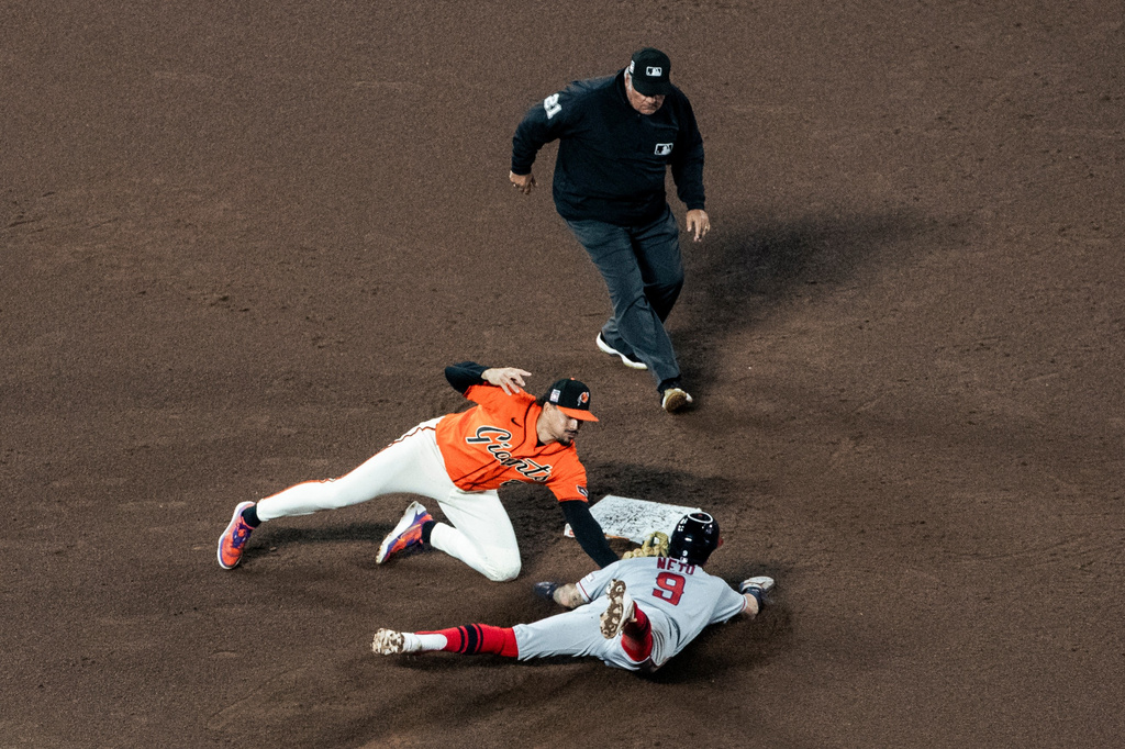 San Francisco Giants shortstop Willy Adames (2) tags out Los Angeles Angels' Zach Neto (9) on second base during a steal attempt in the fifth inning of their baseball game in San Francisco, Friday, July 24, 2026. (Stephen Lam/San Francisco Chronicle via AP)