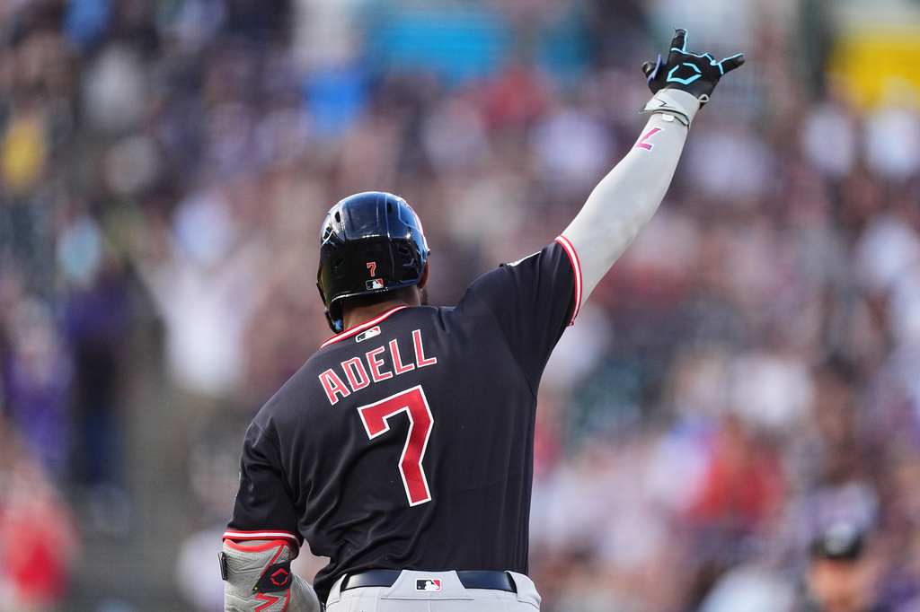 Cleveland Guardians' Jo Adell gestures to the bullpen as he circles tha bases after hitting a three-run home run off Colorado Rockies starting pitcher Gabriel Hughes in the fourth inning of a baseball game Saturday, Aug. 22, 2026, in Denver. (AP Photo/David Zalubowski)