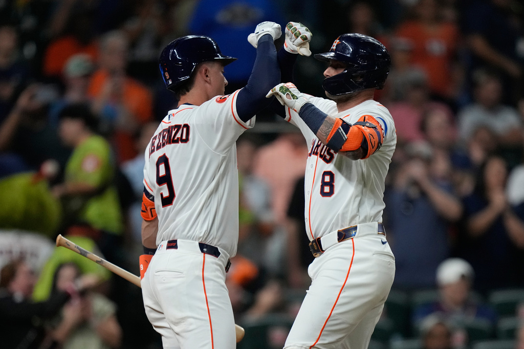 Houston Astros' Christian Walker (8) celebrates with Zach Dezenzo after hitting a home run during the fifth inning of a baseball game against the Seattle Mariners in Houston, Wednesday, May 13, 2026. (AP Photo/Ashley Landis)