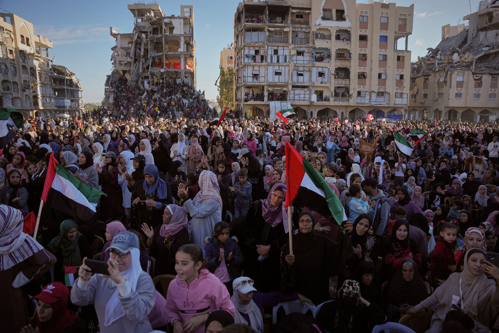Palestinian watch and celebrate a mass wedding ceremony in Hamad City in Khan Younis, Gaza Strip, Tuesday, Dec. 2, 2025. (AP Photo/Abdel Kareem Hana)