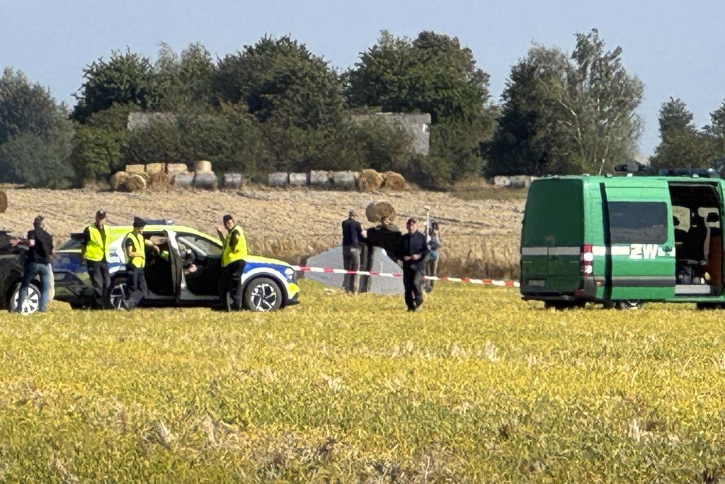 Police and Military Police secure parts of a damaged UAV shot down by Polish authorities at a site in Wohyn, Poland, Wednesday, Sept. 10, 2025.(AP Photo/Rafal Niedzielski)