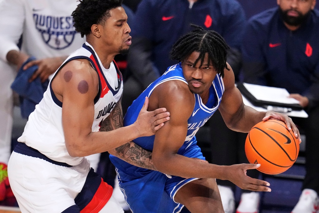 Saint Louis guard Amari McCottry, right, is defended by Duquesne guard Jimmie Williams during the first half of an NCAA college basketball game in Pittsburgh, Tuesday, Jan. 20, 2026. (AP Photo/Gene J. Puskar)