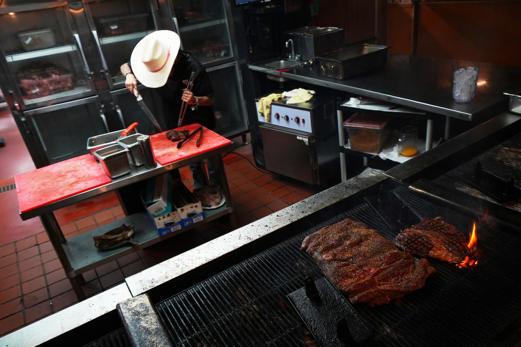 A cook prepares a 72 oz steak at Big Texan Steak Ranch, a roadside staple along Route 66 in Amarillo, Texas, Thursday, Nov. 20, 2025. (AP Photo/Julio Cortez)