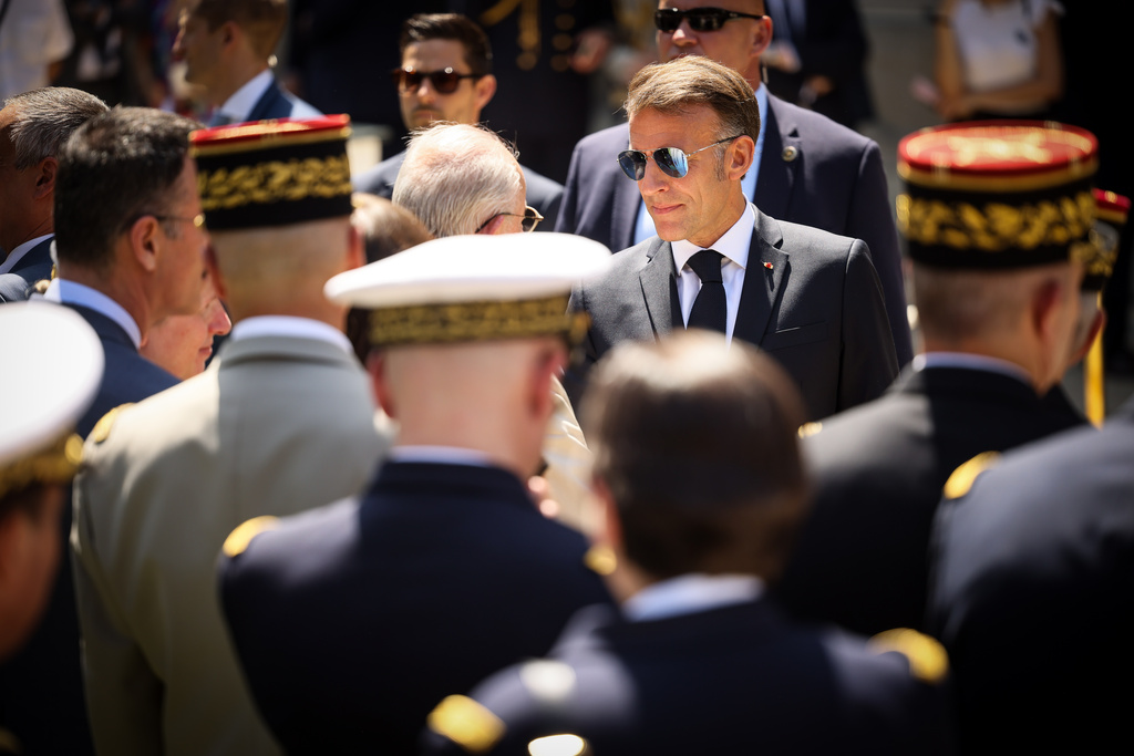 French President Emmanuel Macron greets senior military officers after his traditional address to the armed forces on the eve of the Bastille Day parade at the Ministry of Defense in Paris, Monday, July 13, 2026. (AP Photo/Thomas Padilla, Pool)
