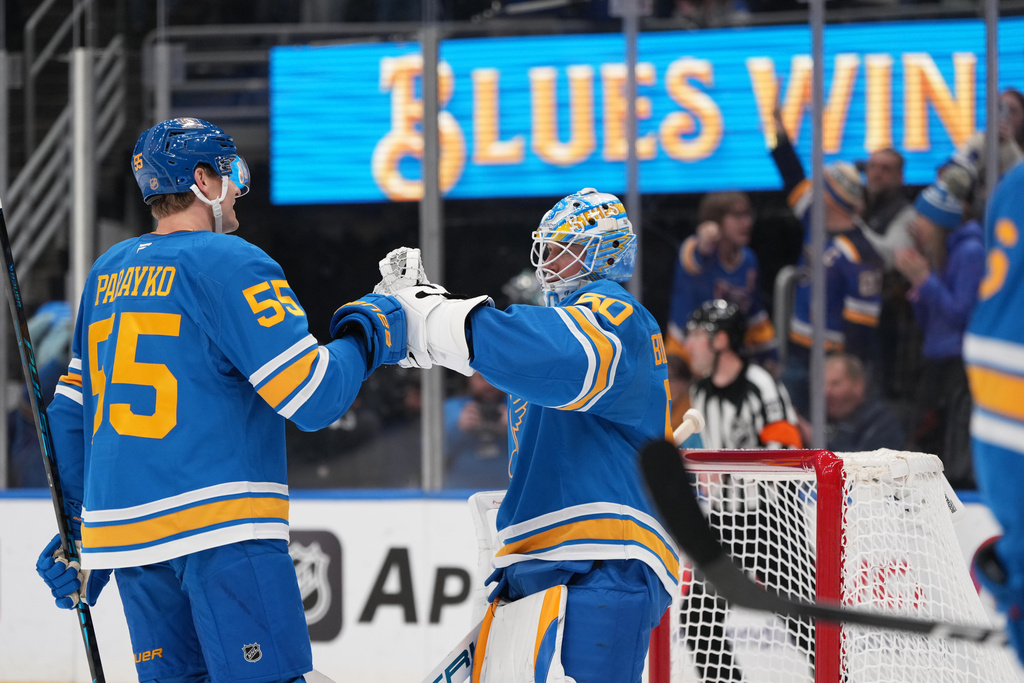 St. Louis Blues goaltender Jordan Binnington (50) and Colton Parayko (55) celebrate a victory over the Montreal Canadiens following an NHL hockey game Saturday, Jan. 3, 2026, in St. Louis. (AP Photo/Jeff Roberson)