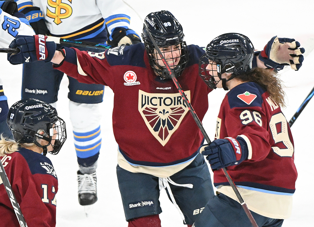 Montreal Victoire's Natalie Mlynkova (96) celebrates with teammates Skylar Irving (88) and Dara Greig (17) after scoring against the Toronto Sceptres during first period PWHL hockey action in Laval, Que., Wednesday, Jan. 28, 2026. (Graham Hughes/The Canadian Press via AP)